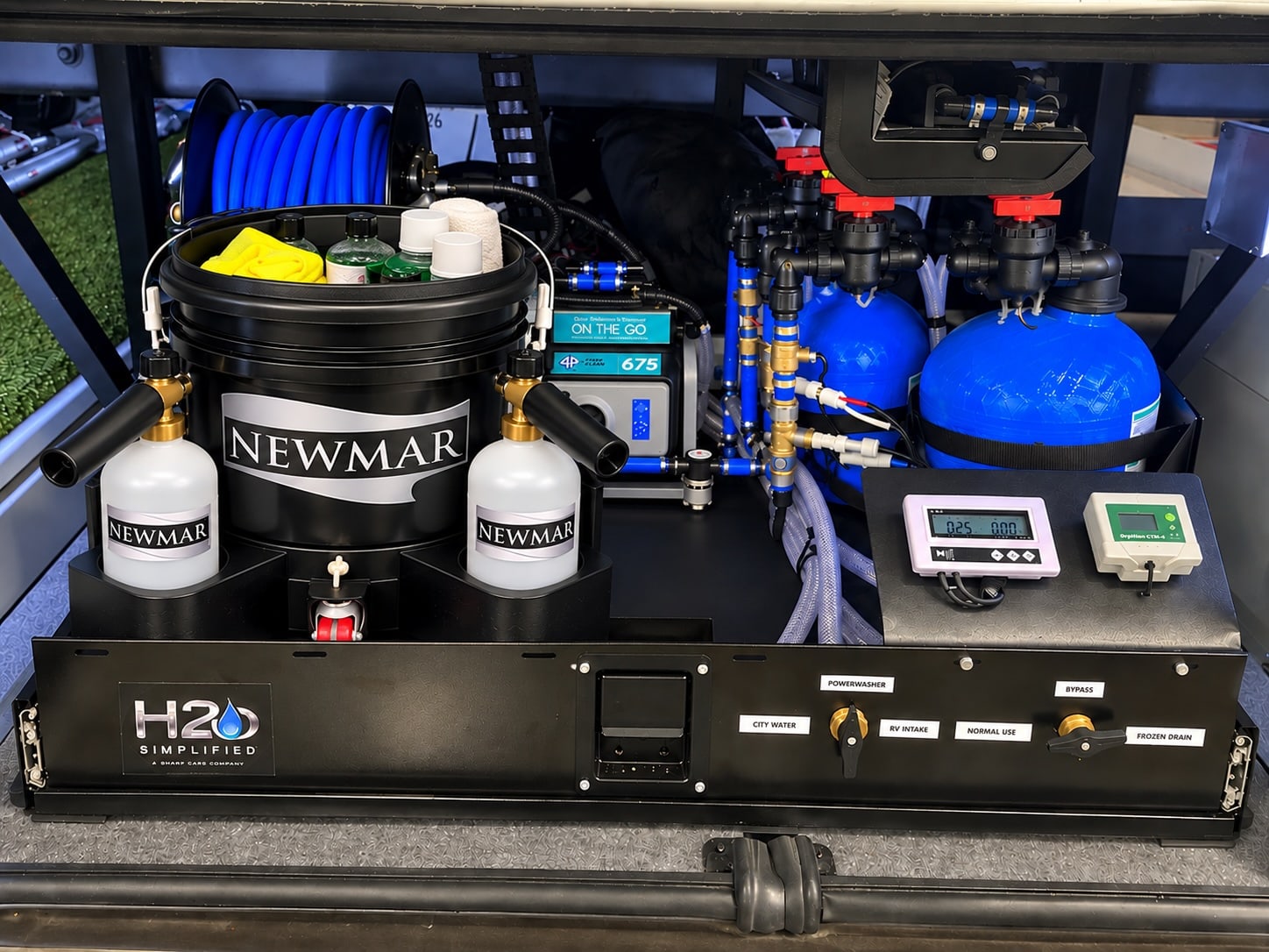 Complete H2O Simplified installation with the hose reel, pressure washer, treatment tanks, front controls and Newmar wash kit together in the service bay